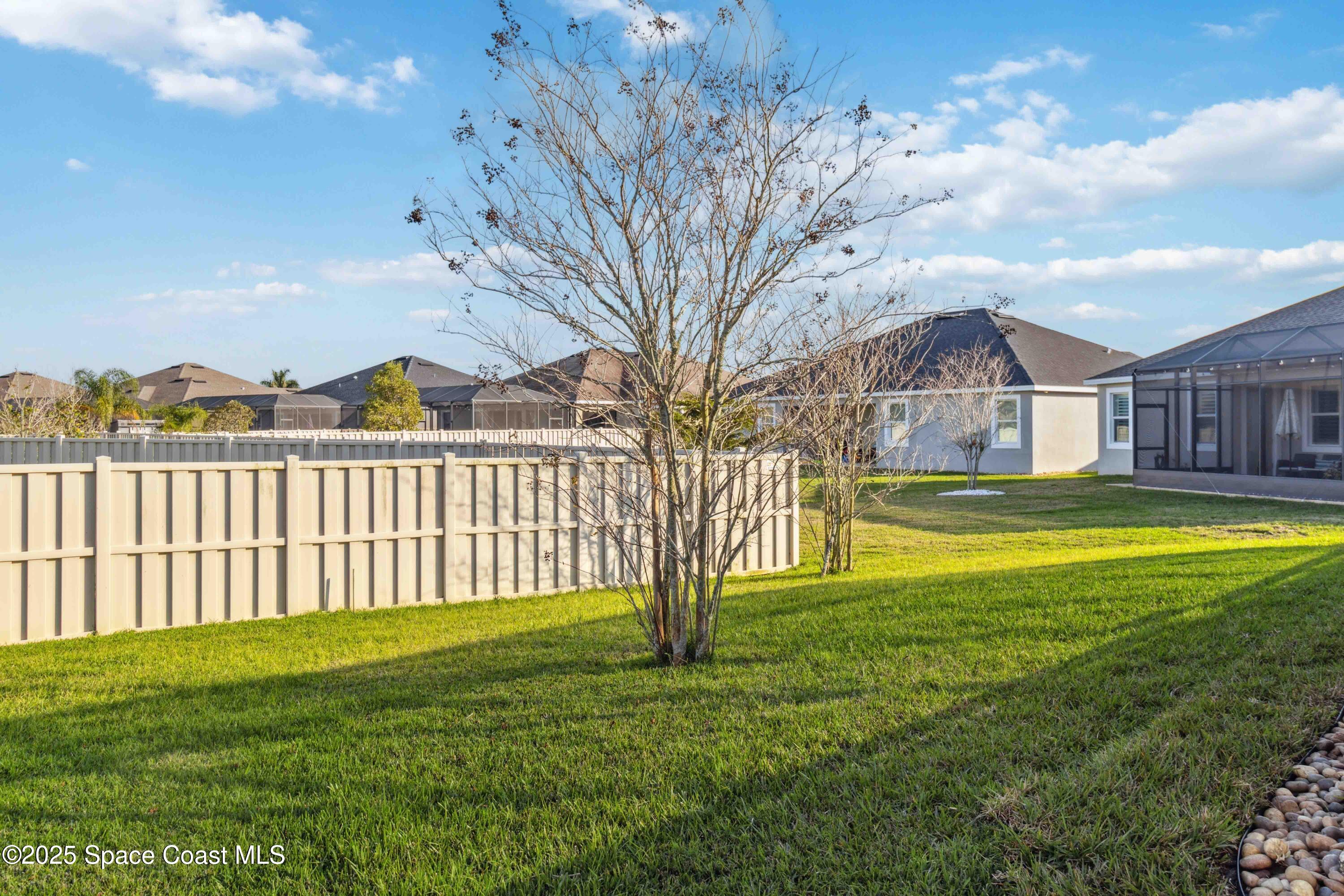 7565 Millbrook Avenue Melbourne, FL 32940 - Photo 35 of 47 a view of a house with a big yard