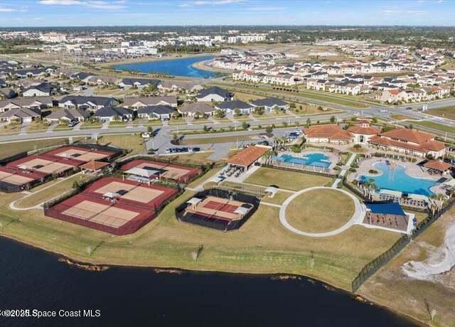 7565 Millbrook Avenue Melbourne, FL 32940 - Photo 42 of 47 an aerial view of residential houses with outdoor space