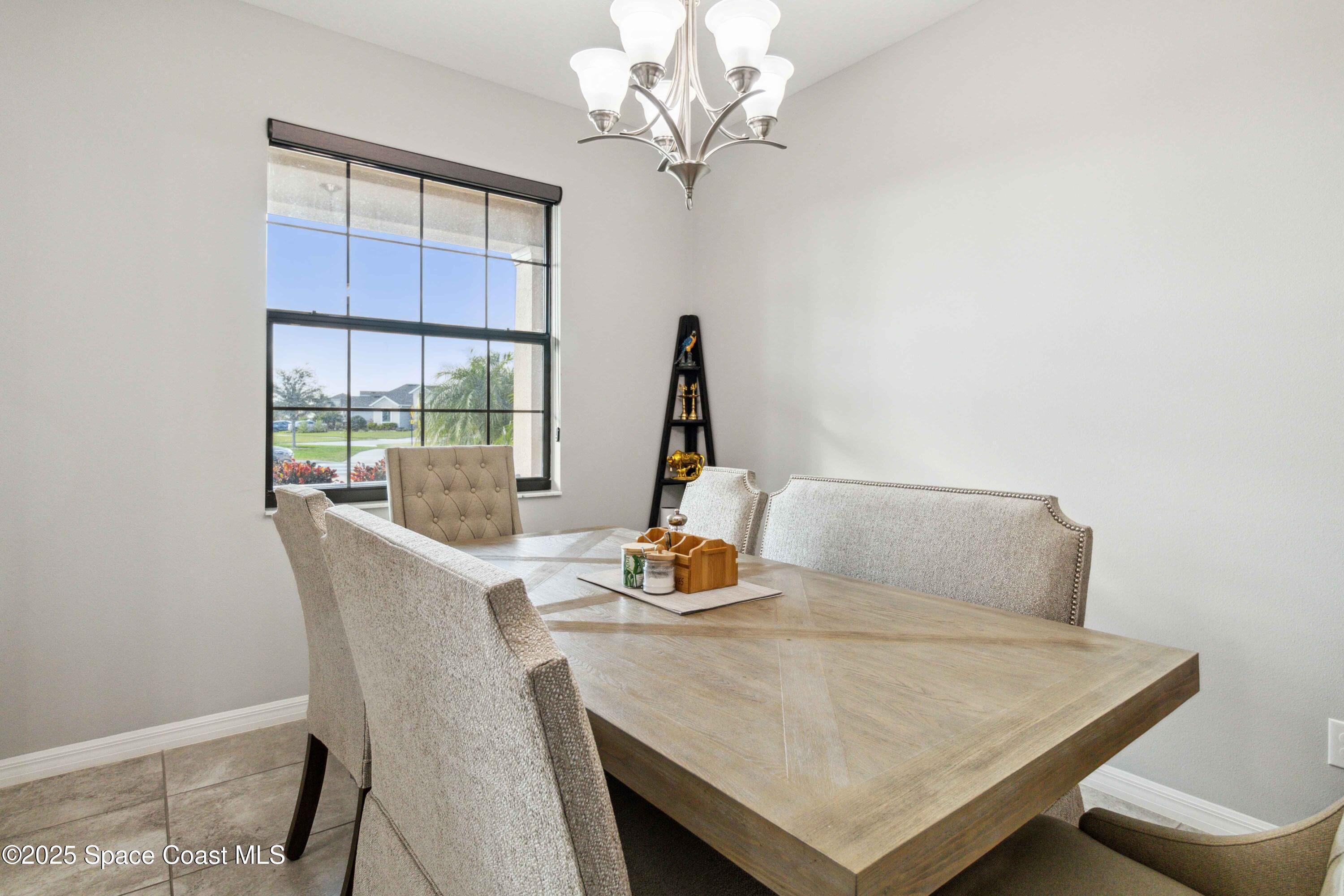 7565 Millbrook Avenue Melbourne, FL 32940 - Photo 6 of 47 a dining room with furniture and window