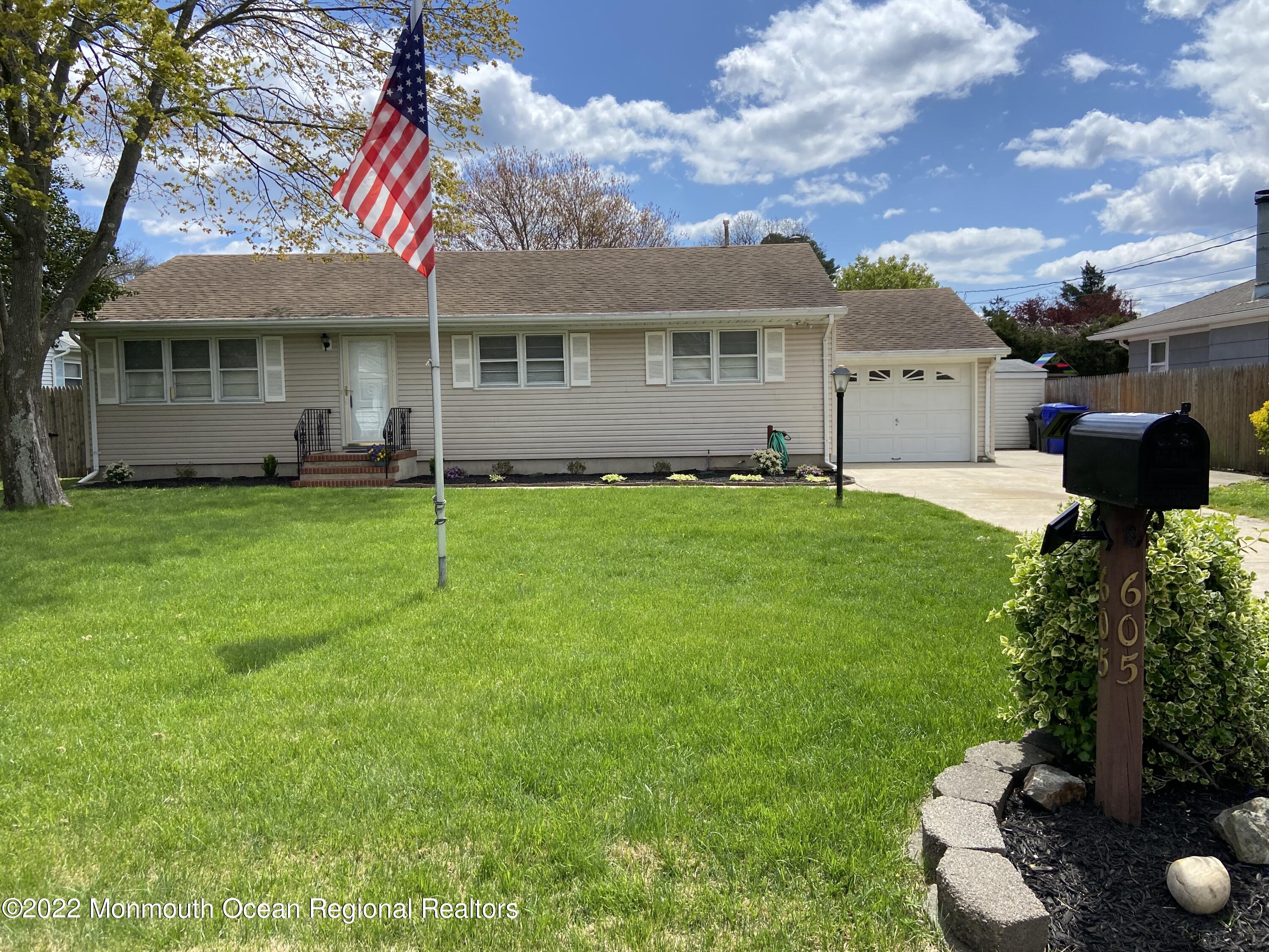 a front view of a house with a garden and plants