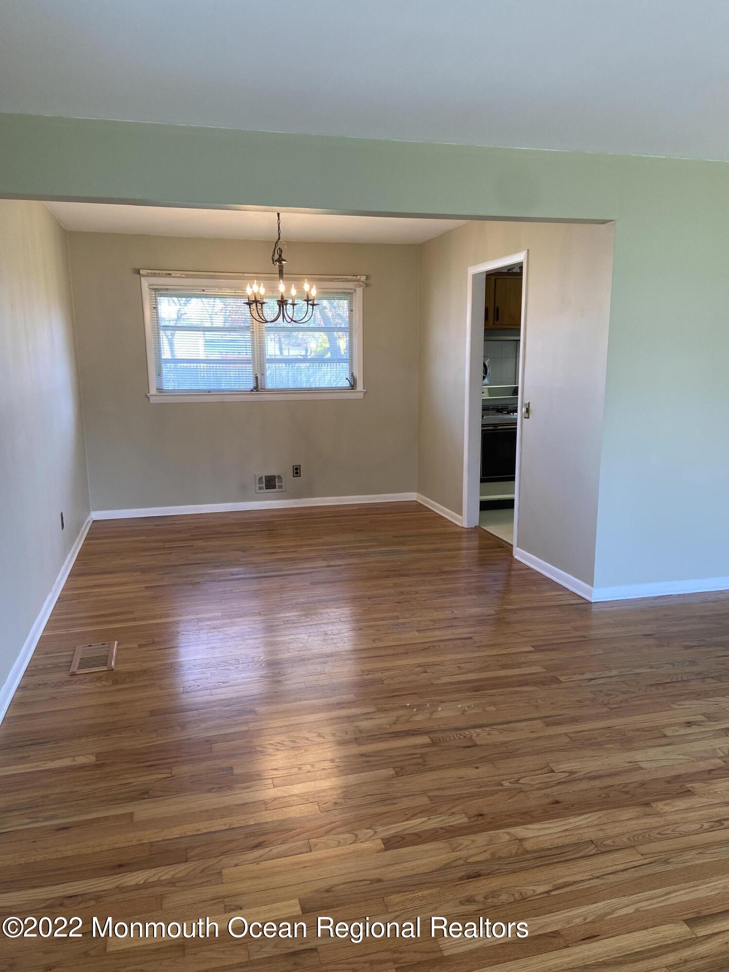 605 Adamston Road Brick, NJ 08723 - Photo 3 of 16 a view of a room with wooden floor a ceiling fan and staircase