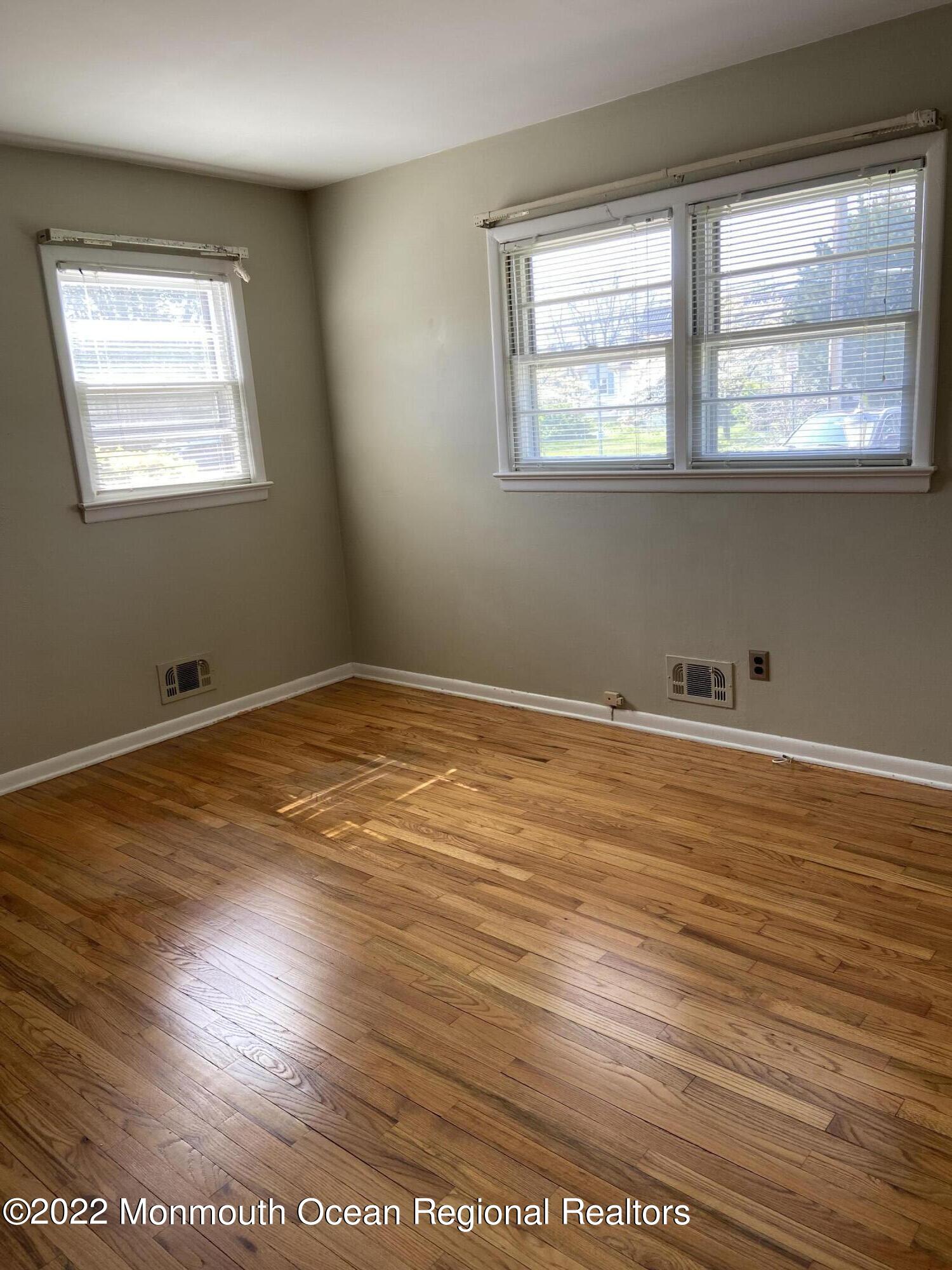605 Adamston Road Brick, NJ 08723 - Photo 7 of 16 a view of an empty room with wooden floor and a window