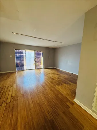 a view of an empty room and wooden floor