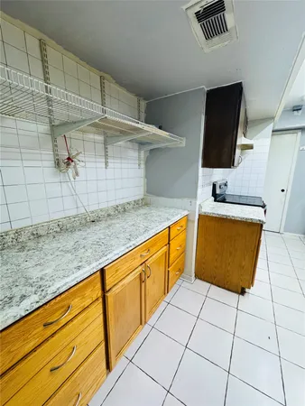 a kitchen with granite countertop a sink and a stove