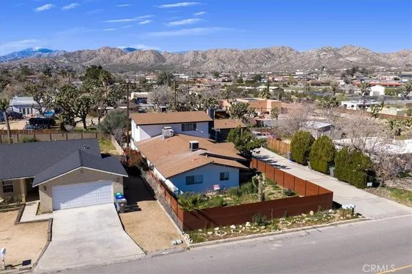 an aerial view of a residential houses with city view