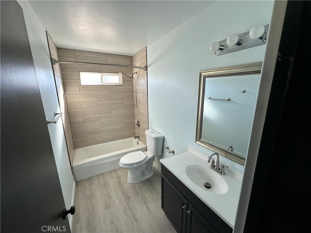 7428 Acoma Trail Yucca Valley, CA 92284 - Photo 15 of 18 a bathroom with a sink a toilet a mirror and shower