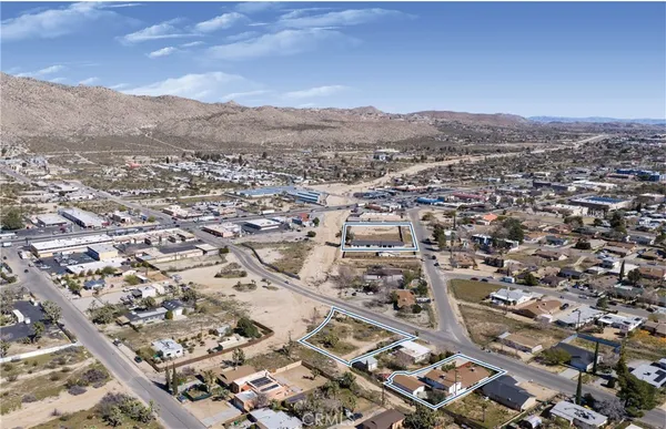 an aerial view of residential houses with city view