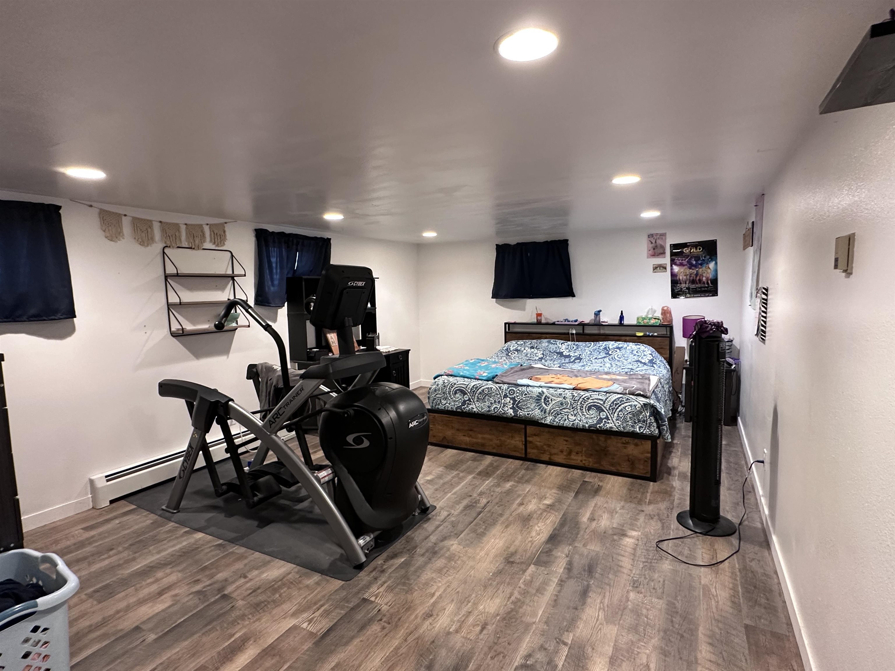 9456 6075th Road Montrose, CO 81403 - Photo 24 of 36 a bedroom with a bed a mirror and a flat screen tv