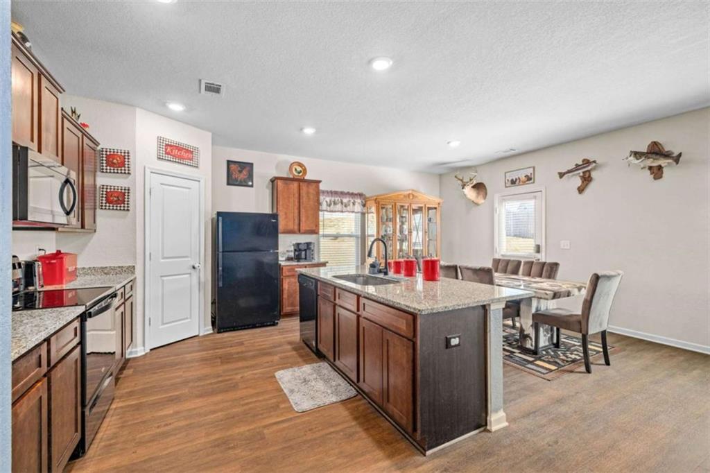 306 Seasons Valley Pendergrass, GA 30567 - Photo 13 of 37 a kitchen with stainless steel appliances granite countertop a refrigerator and a stove top oven