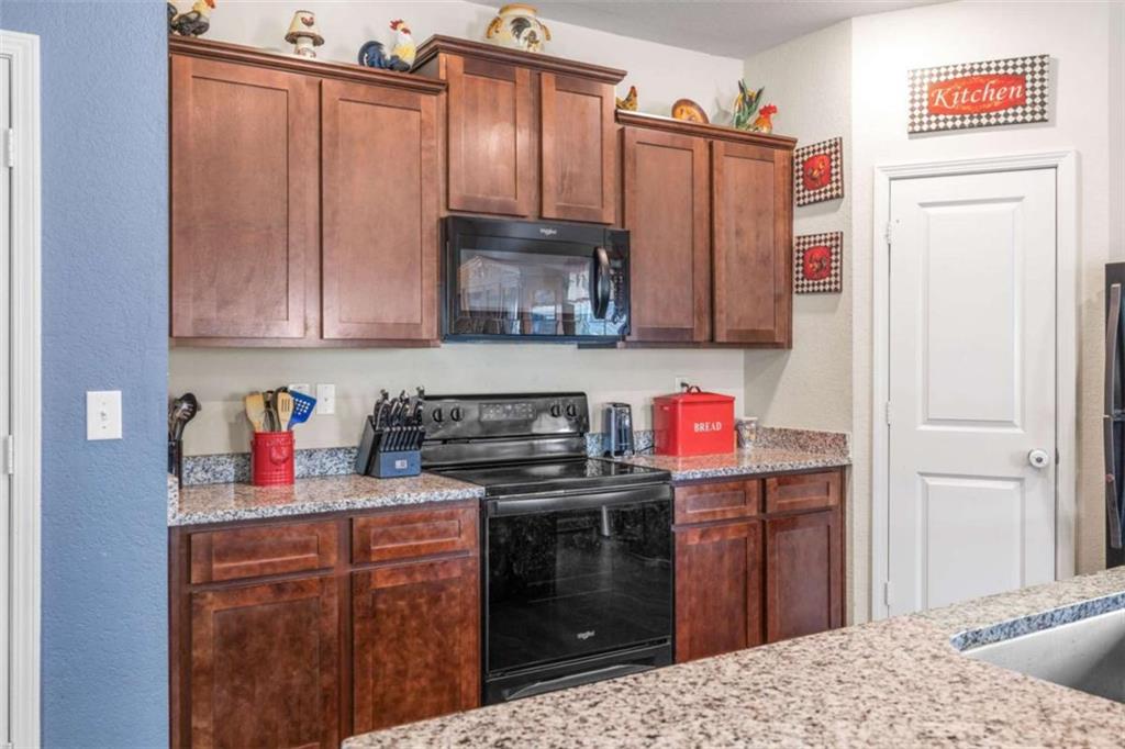 306 Seasons Valley Pendergrass, GA 30567 - Photo 14 of 37 a kitchen with stainless steel appliances granite countertop a refrigerator stove and sink