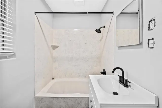 a bathroom with a sink and shower