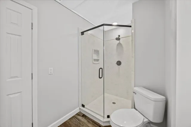 a bathroom with a toilet and a shower