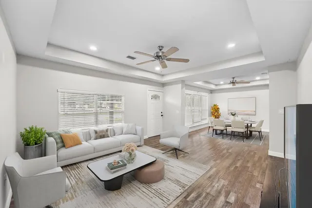 a living room with furniture and a chandelier
