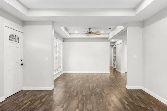 a view of an empty room with wooden floor