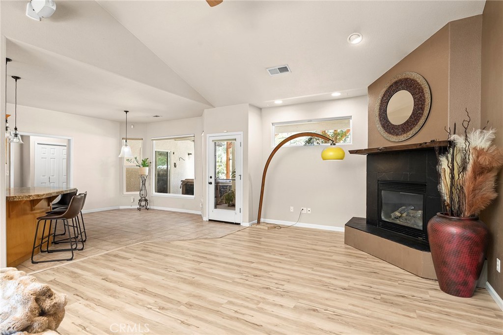 2262 Honey Run Road Chico, CA 95928 - Photo 8 of 74 a living room with furniture a flat screen tv and a fireplace