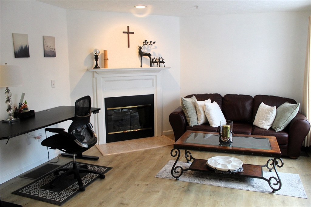 38 Georgetown Drive, Unit 38 Nashua, NH 03062 - Photo 12 of 26 a view of a workspace with furniture and a fireplace
