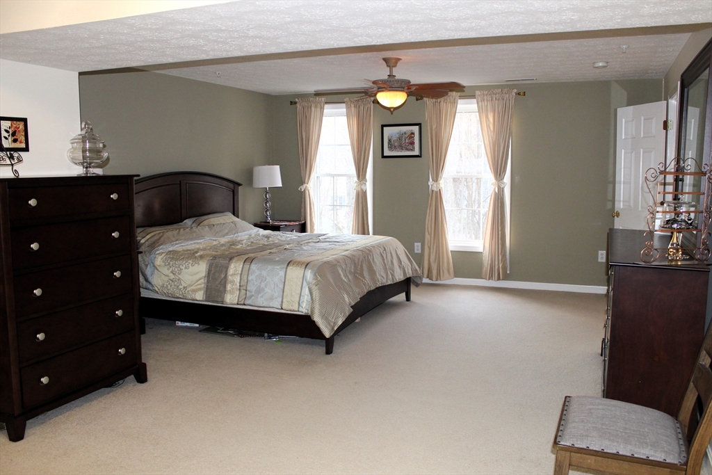 38 Georgetown Drive, Unit 38 Nashua, NH 03062 - Photo 14 of 26 a bedroom with a bed and window