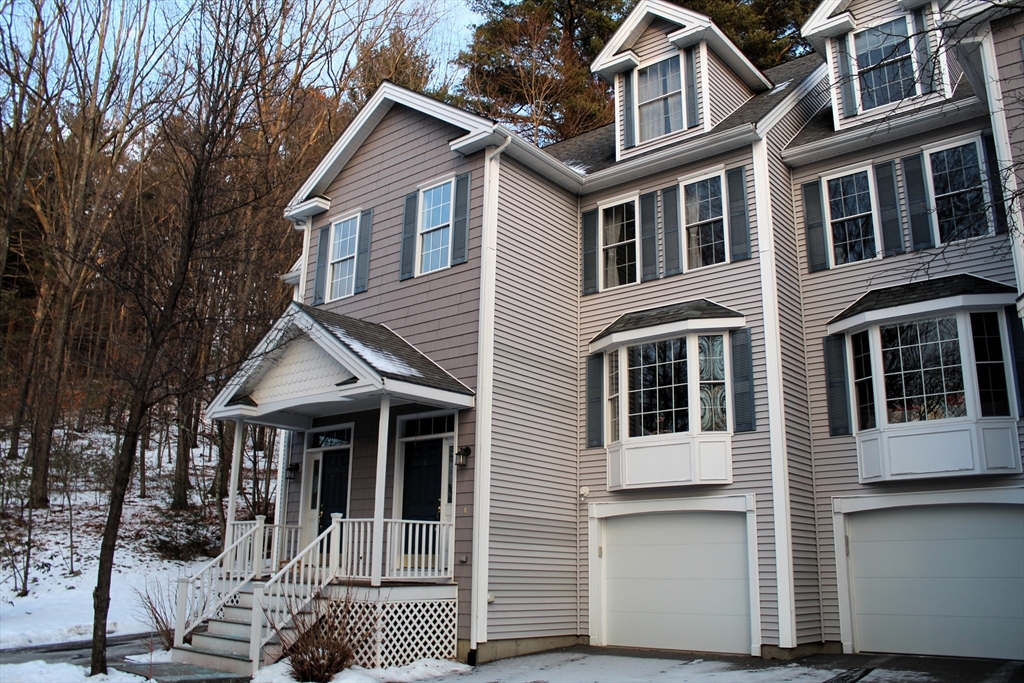 38 Georgetown Drive, Unit 38 Nashua, NH 03062 - Photo 2 of 26 a view of a white house with large windows