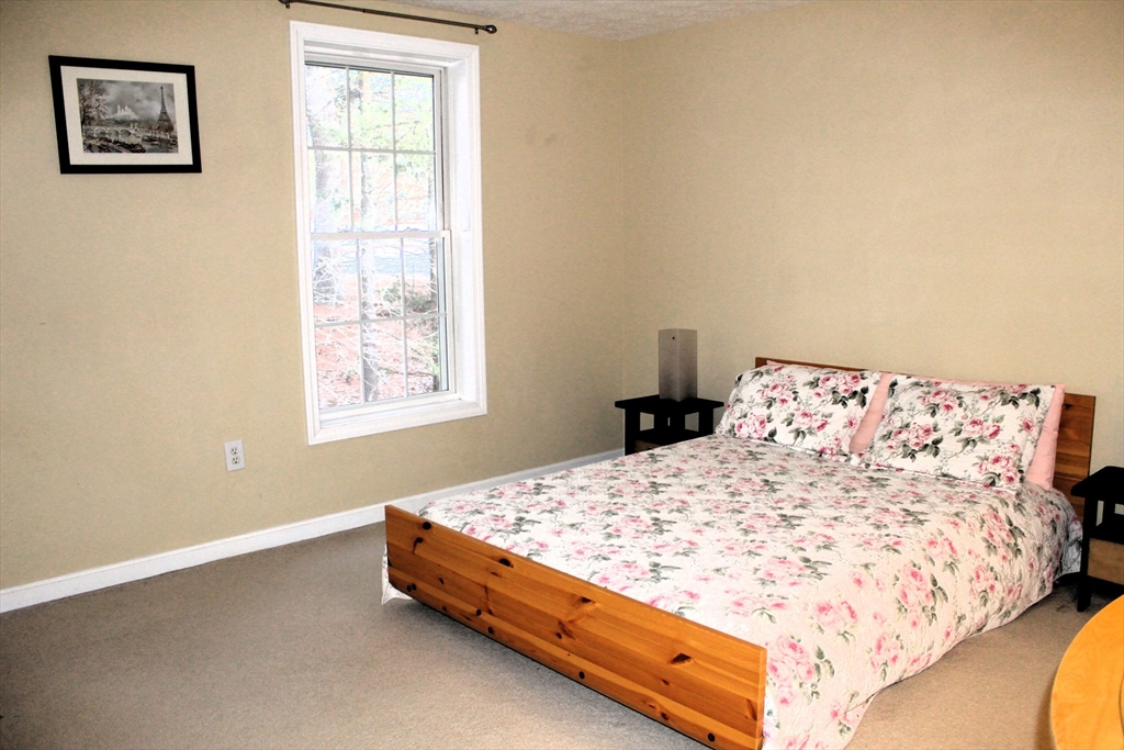 38 Georgetown Drive, Unit 38 Nashua, NH 03062 - Photo 21 of 26 a bed sitting in a bedroom next to a window