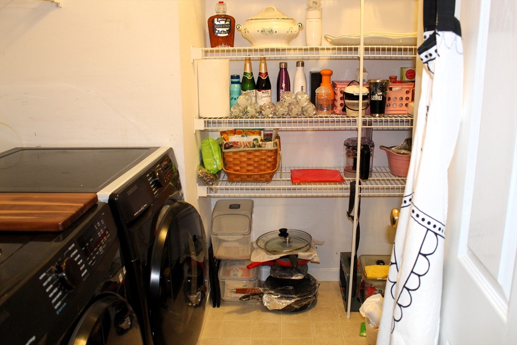 38 Georgetown Drive, Unit 38 Nashua, NH 03062 - Photo 7 of 26 a storage room with washer and dryer