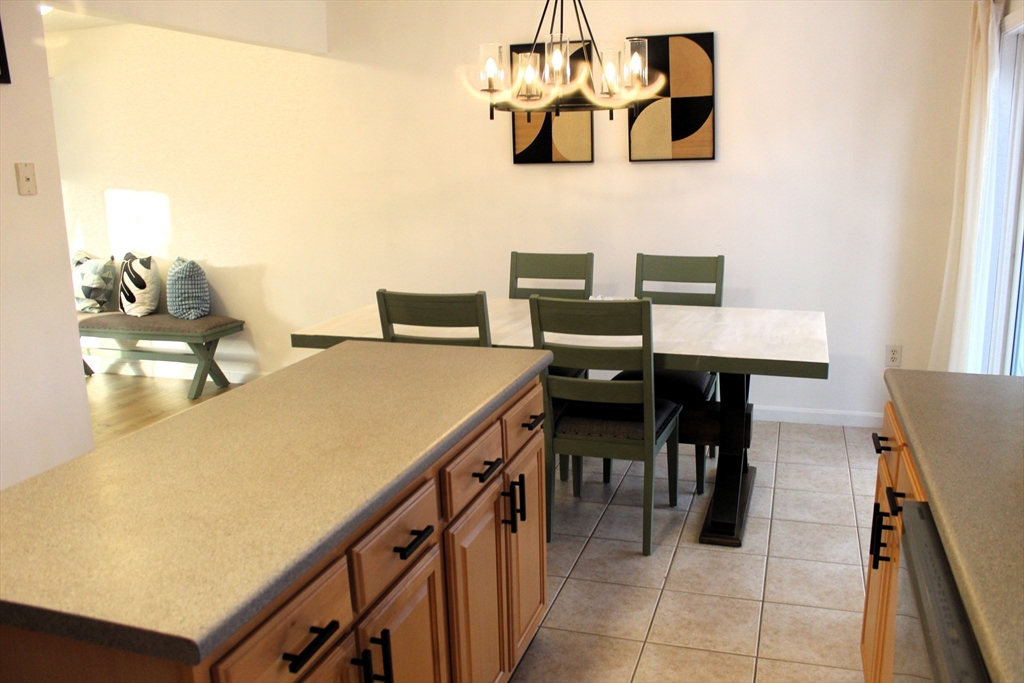 38 Georgetown Drive, Unit 38 Nashua, NH 03062 - Photo 9 of 26 a view of a dining room with furniture and chandelier