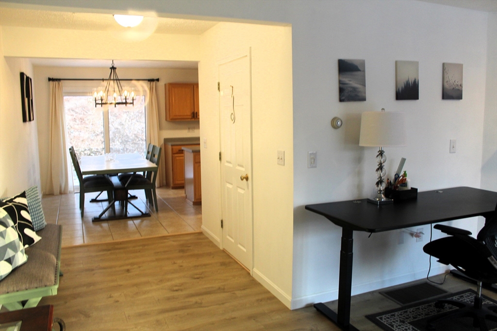 38 Georgetown Drive, Unit 38 Nashua, NH 03062 - Photo 10 of 26 a view of a room with a table and chairs