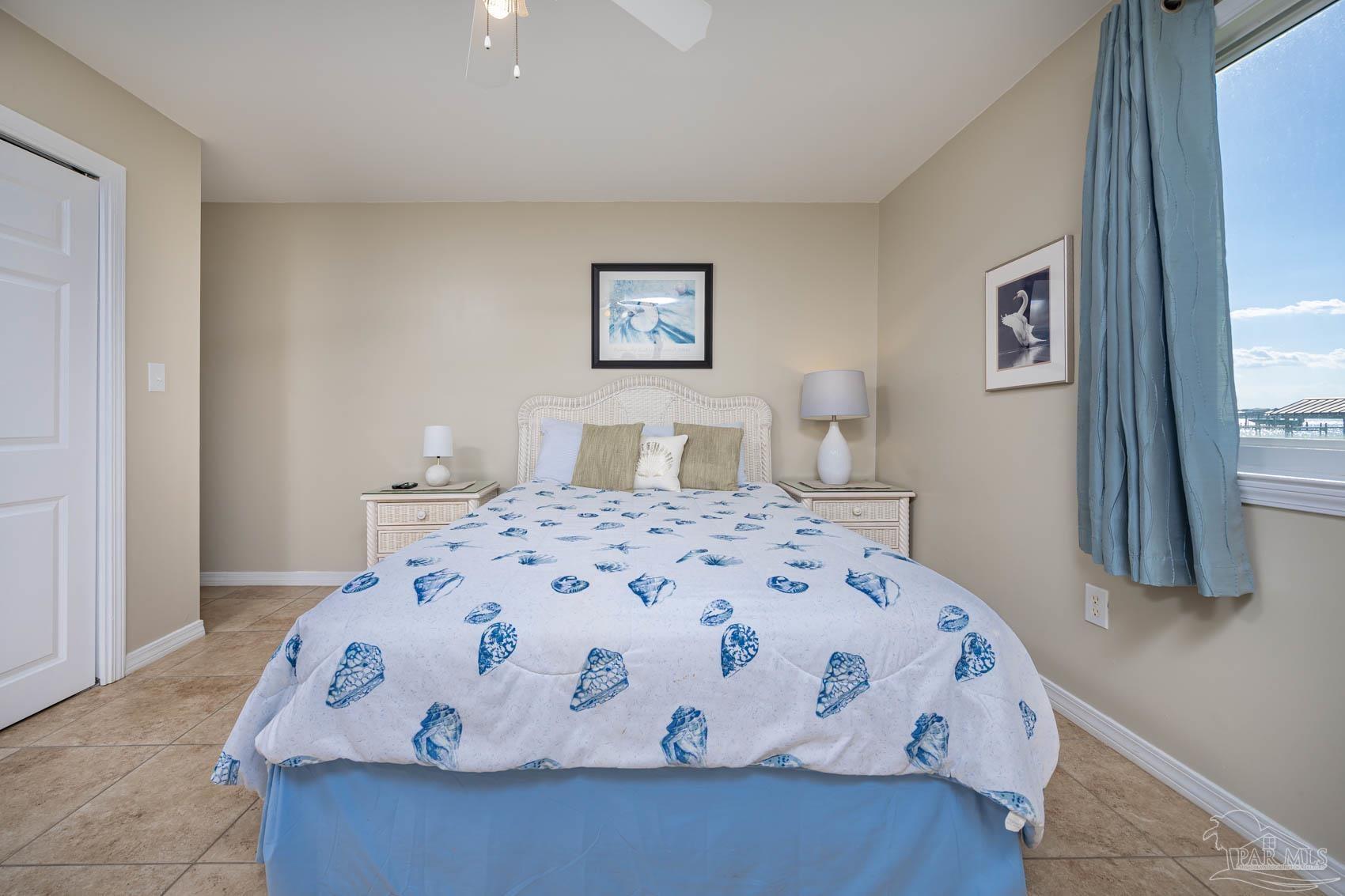 16470 Perdido Key Drive, Unit B13 Perdido Key, FL 32507 - Photo 13 of 17 a bedroom with a large bed and a wooden floor