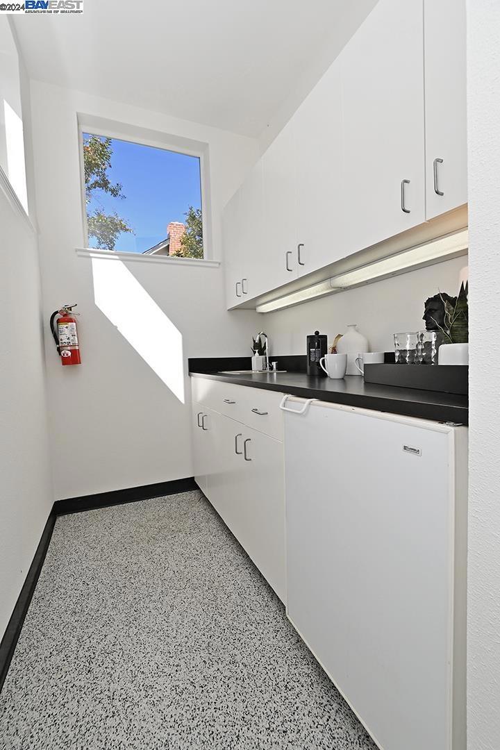 148 Spring Street Pleasanton, CA 94566 - Photo 14 of 46 a kitchen with a sink and cabinets