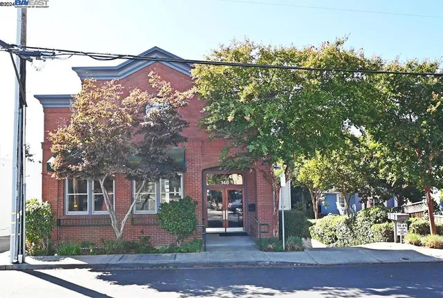 front view of a house with a tree