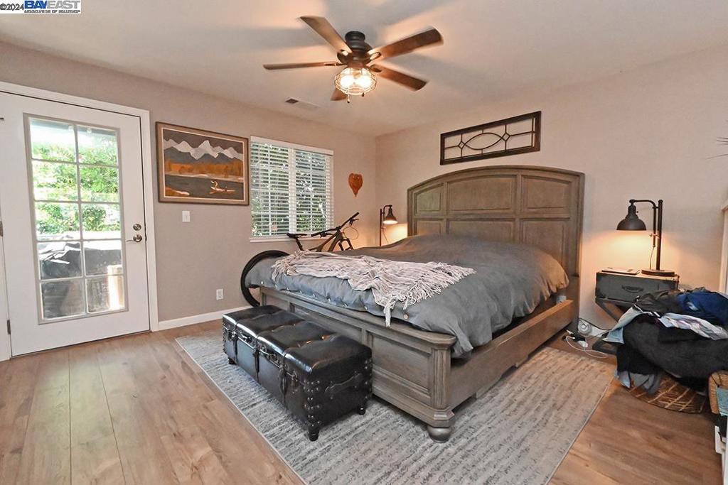 148 Spring Street Pleasanton, CA 94566 - Photo 28 of 46 a bedroom with a bed and wooden floor