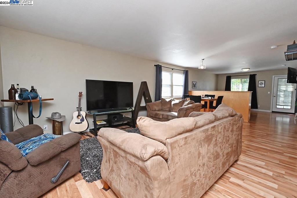 148 Spring Street Pleasanton, CA 94566 - Photo 31 of 46 a living room with furniture and a flat screen tv