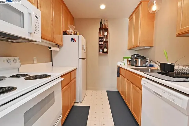 a bed sitting in a spacious bedroom next to a window
