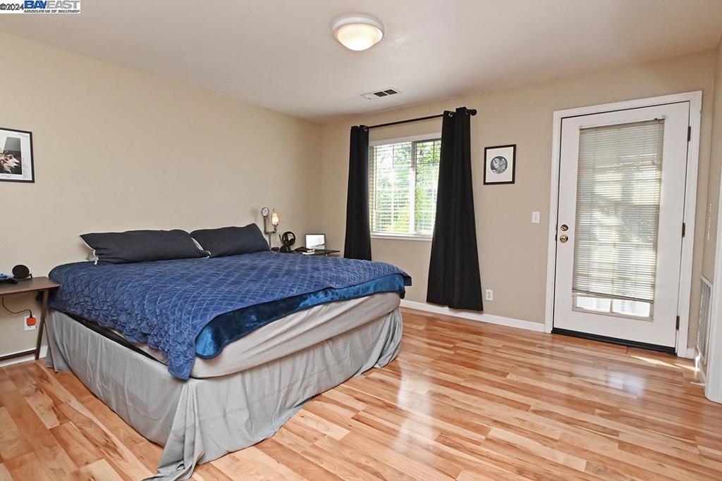 148 Spring Street Pleasanton, CA 94566 - Photo 35 of 46 a bed sitting in a spacious bedroom next to a window