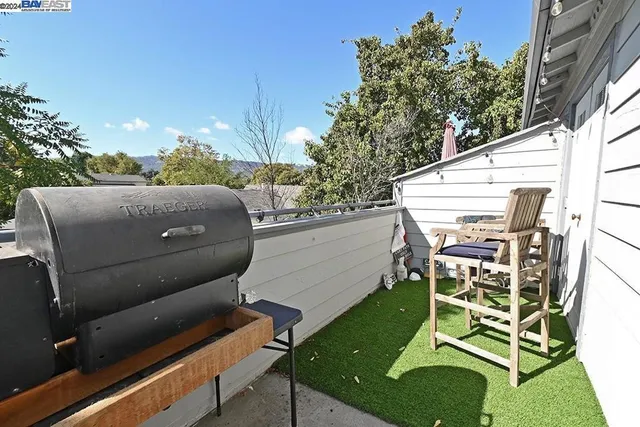 a living room with furniture hard wood floor and a table