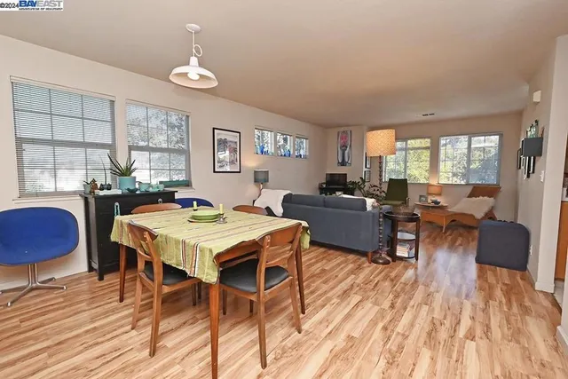 a view of a dining room with furniture and wooden floor