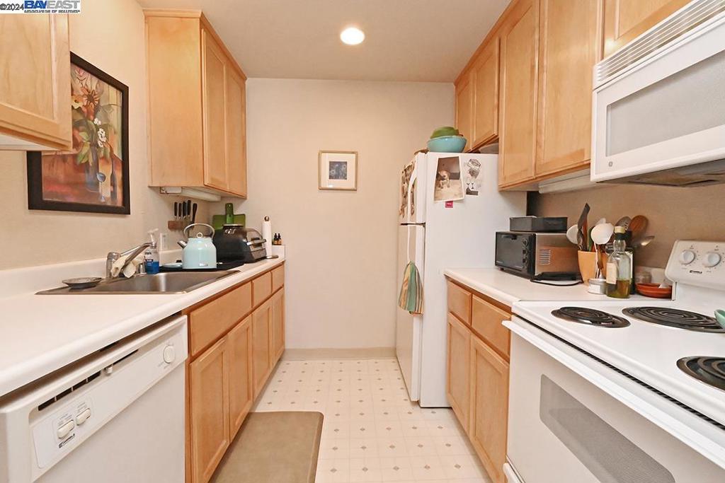 148 Spring Street Pleasanton, CA 94566 - Photo 41 of 46 a kitchen with white cabinets and white appliances