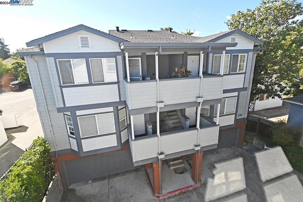 148 Spring Street Pleasanton, CA 94566 - Photo 6 of 46 a view of a large white house with large windows