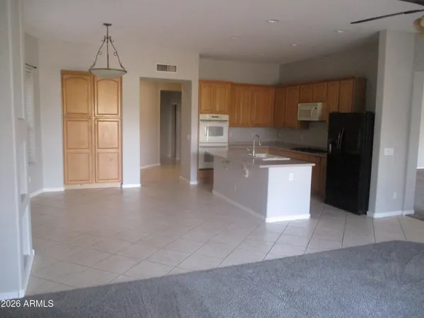 a kitchen with stainless steel appliances a refrigerator a stove a sink and dishwasher