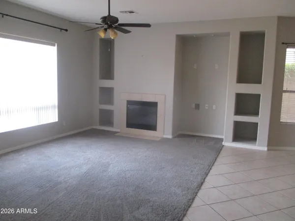 a view of empty room with ceiling fan