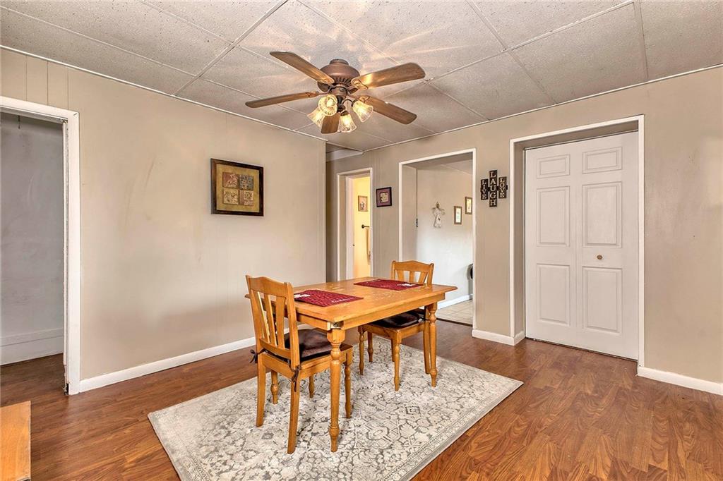 8002 Hayward Street Irwin, PA 15642 - Photo 10 of 31 a dining room with wooden floor and a chandelier