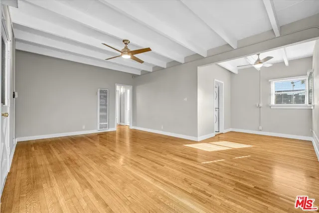 a view of a room with window and wooden floor