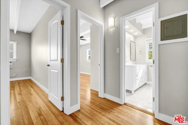 a view of a hallway with wooden floor