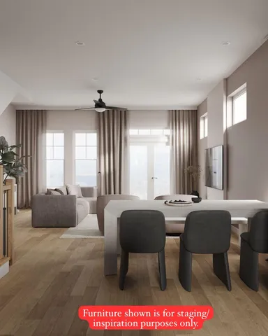 a living room with furniture a large window and a chandelier