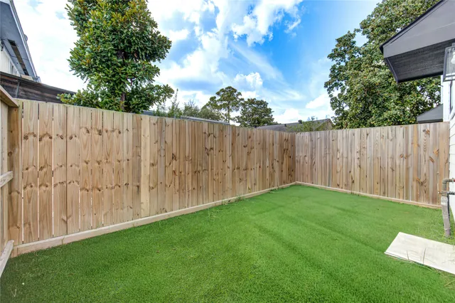 a view of yard with wooden fence