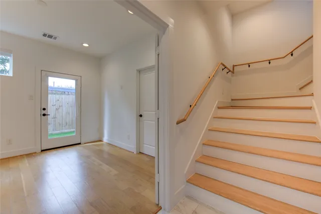 a view of entryway with wooden floor and stairs