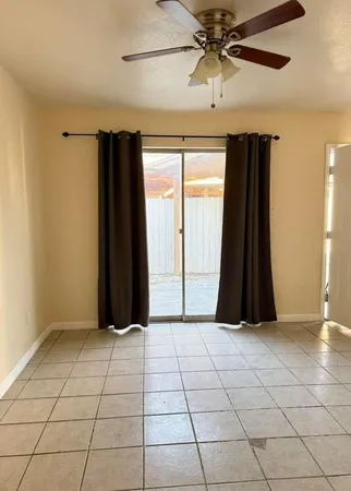 a view of entryway with a ceiling fan and window