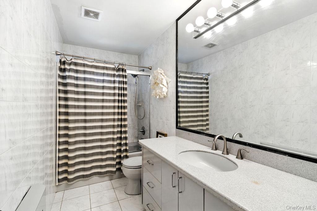 21 Macarthur Avenue Plainview, NY 11803 - Photo 13 of 26 a bathroom with a sink and a mirror
