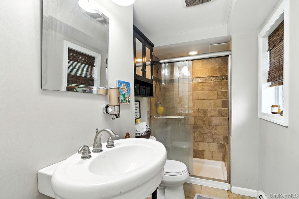 21 Macarthur Avenue Plainview, NY 11803 - Photo 18 of 26 a bathroom with a sink toilet and shower