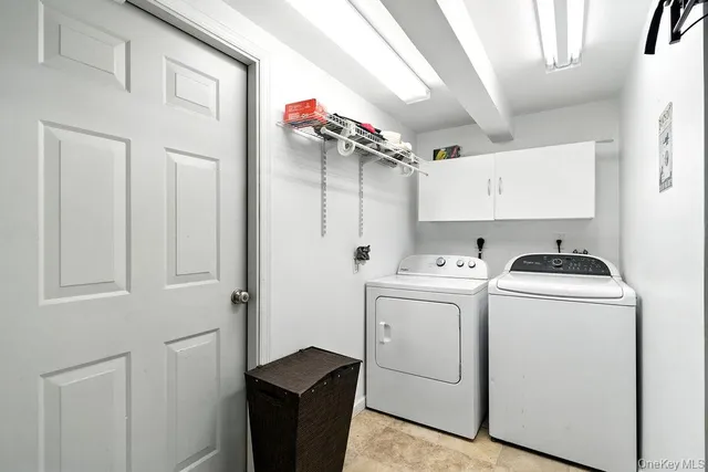 a view of storage and utility room with washer and dryer