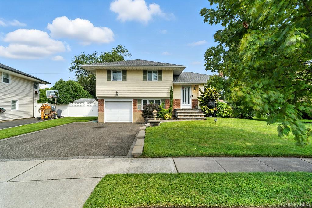 21 Macarthur Avenue Plainview, NY 11803 - Photo 2 of 26 a front view of a house with a yard